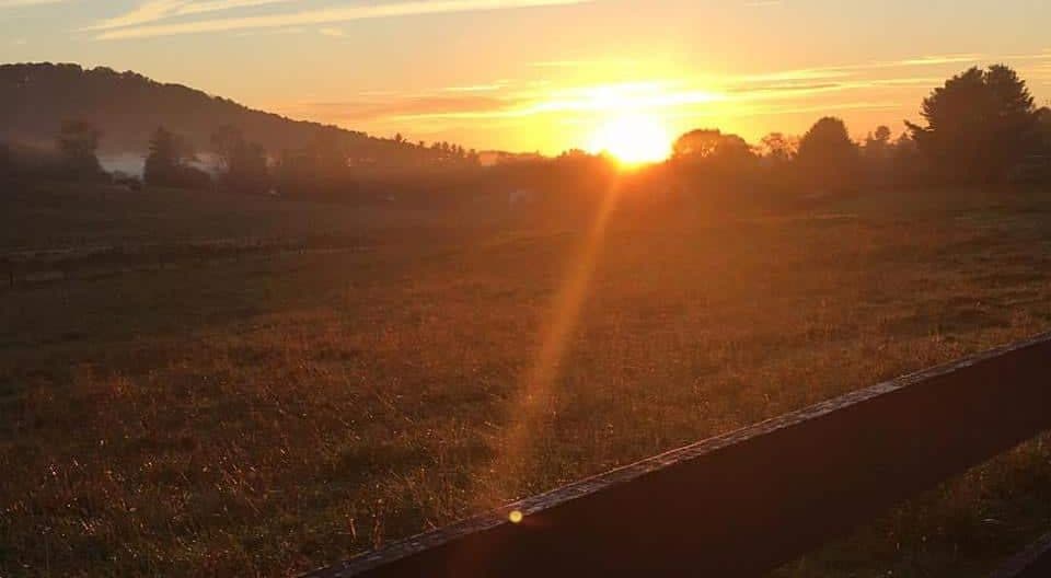 The sun setting behind mountains